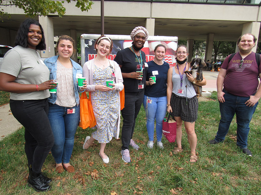 A smiling group of graduate students outside